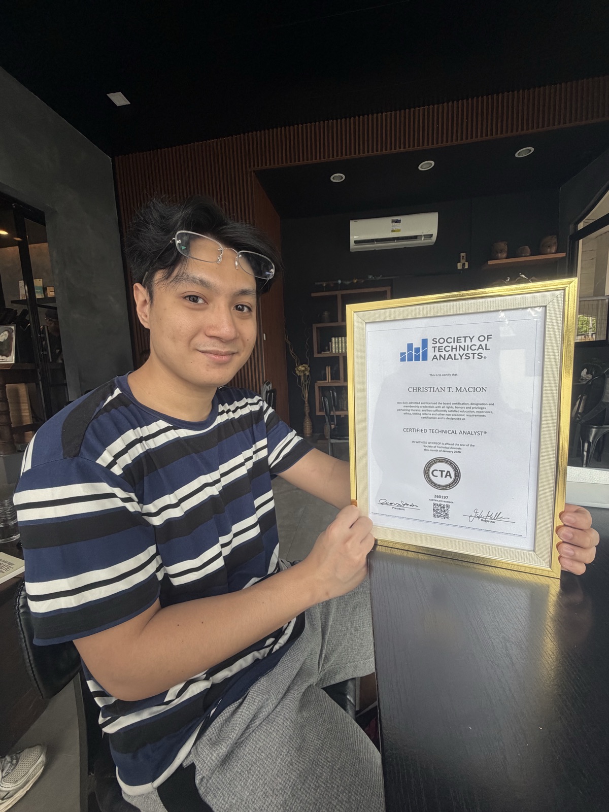 Christian T. Macion holding the Society of Technical Analysts Certified Technical Analyst® (CTA) certificate, certificate number 260197, awarded January 2026. Photographic proof of the Tier-1 CTA designation.